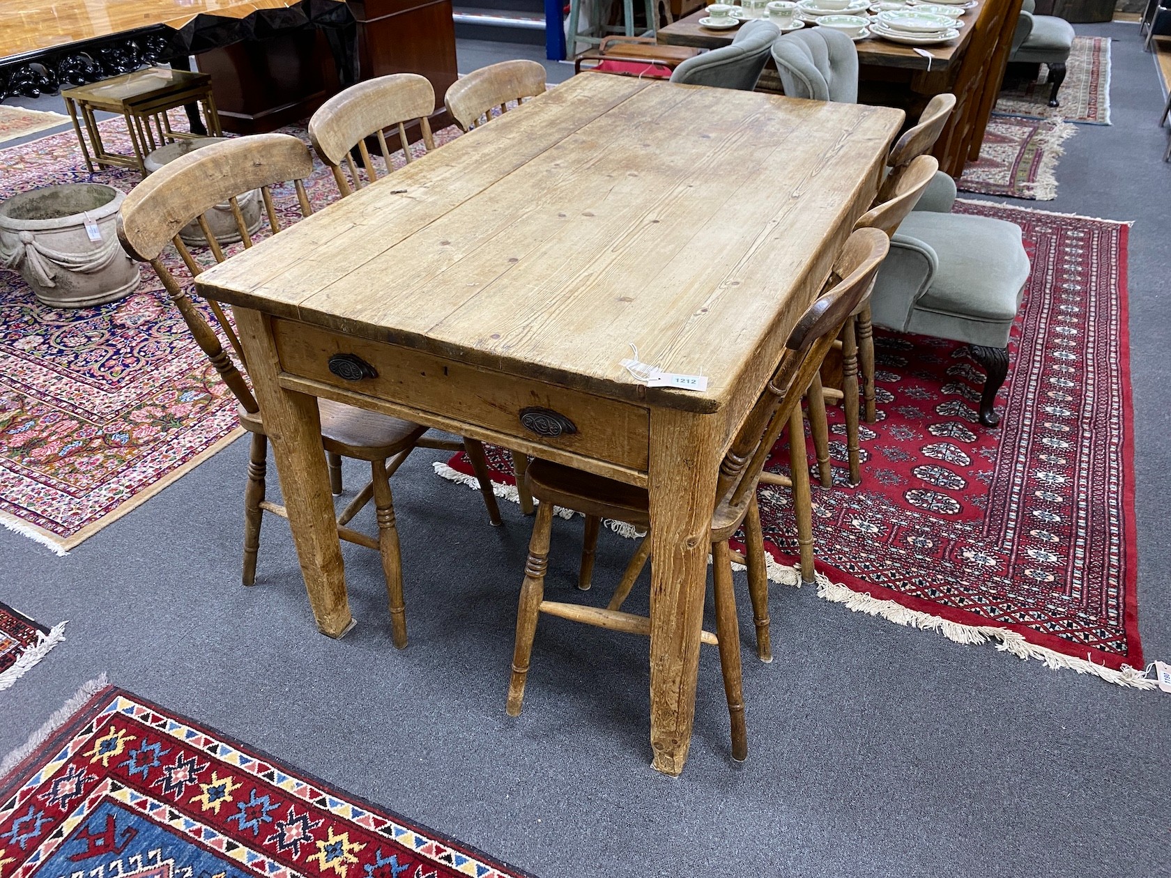 A Victorian rectangular pine kitchen table, length 136cm, depth 81cm, height 77cm together with six Victorian elm and beech Windsor comb back kitchen chairs